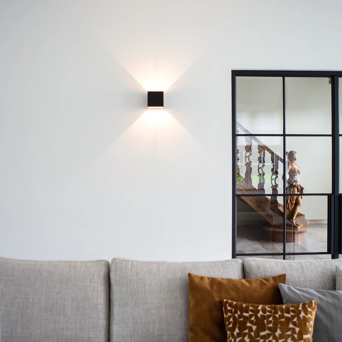 SensoCube Wandlampe in Schwarz im Wohnzimmer über dem Sofa